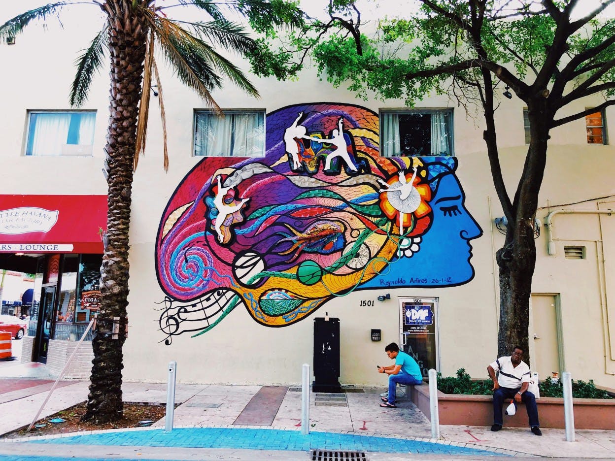 Colorful mural of outside of a palm tree lined building in the Little Havana neighborhood of Miami,
