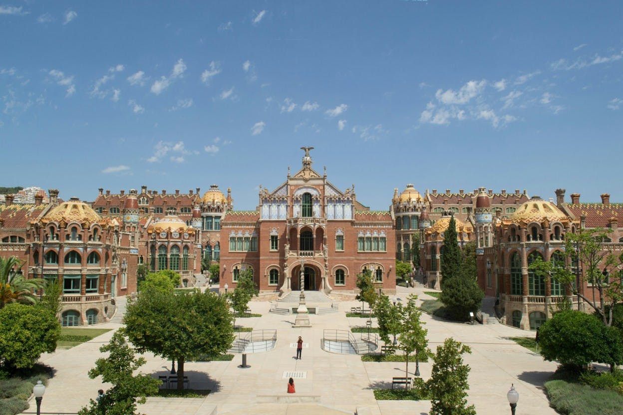 A street view image of the historical Recinte Modernista de Sant Pau, a former hospital and now historical building in the Sant Antoni neighborhood in Barcelona, Spain. The building is a UNESCO world heritage site, and is an architectural masterpiece in the modernist design principles. 